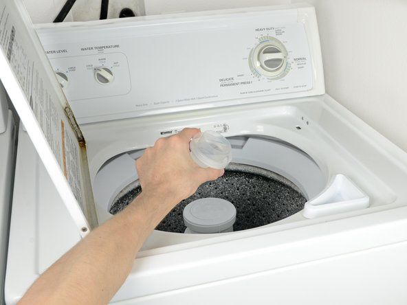 Non versare mai il detersivo per bucato direttamente sui vestiti, versarlo sempre nell'acqua. Versare il sapone direttamente sui vestiti può causare scolorimento.' alt=