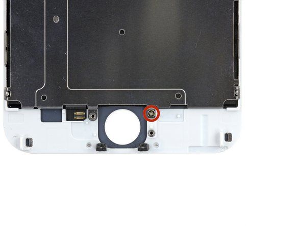 Vyšroubujte dva šrouby Phillips 1,7 mm (jeden nahoře a druhý dole), které připevňují štítovou desku LCD k sestavě displeje.' alt=