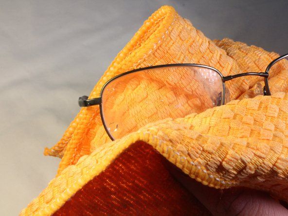 メガネを乾かし、レンズに残っているワックスを取り除くには、清潔な布でメガネを拭き取ります。' alt=