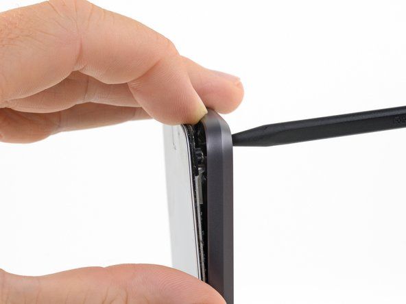 Utilisez un doigt pour maintenir la séparation entre l'assemblage d'écran et la coque arrière pendant que vous retirez le spudger.' alt=
