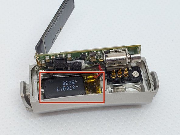 Jakmile se základní deska zvedne, pomocí pinzety odpojíte starou baterii (umístěnou vlevo dole) od krytu. Pamatujte, že jasně žlutá část je součástí baterie.' alt=
